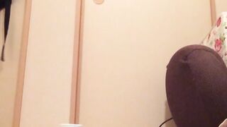 Naughty Japanese teen pees in a cup while putting makeup on