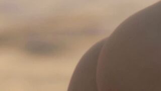On the beach sexy beauty exposes her bare body