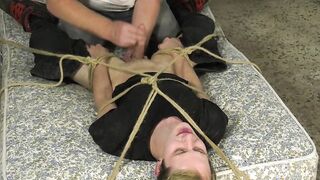 Young blond twinky roped down for a powerful handjob