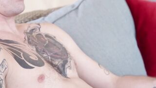 Tattooed gay relaxes outdoors by jacking off his dick
