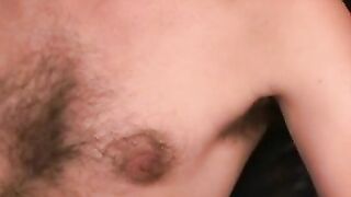 Hairy mature guy pulls out his dick on the sofa and comes