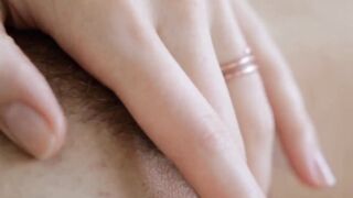 A gorgeous young blonde teases her wet pussy and perky tits