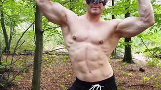 Muscular dude strokes his cock outdoors while wearing a mask