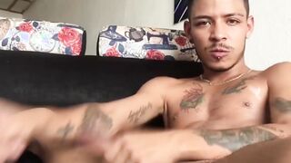 Tattooed Latino amateur Juan jerks off his big dick and cums