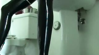 In the bathroom a lesbian dressed skimpily takes a shower and rides a dallio