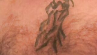 Tattooed mature given a blowjob and anal fingering