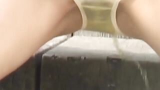 Japanese student plays with her tits while pissing in nature