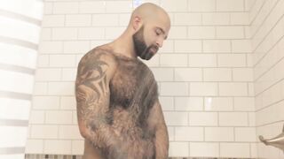 Atlas Grant shows off that bear body and tugs on his dick