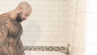 Atlas Grant shows off that bear body and tugs on his dick