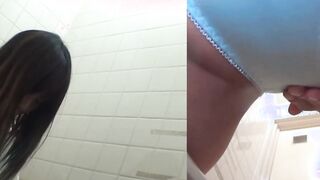 Naughty Japanese babe fingers her pussy in public toilet