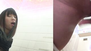 Naughty Japanese babe fingers her pussy in public toilet