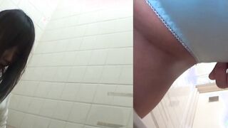 Naughty Japanese babe fingers her pussy in public toilet