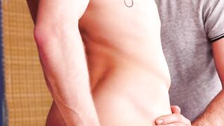 Gay man with a beard stoops down to let his big cock pierce him