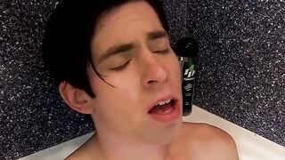 Lad groans as he tugs at his cock and plays with his ass in the shower