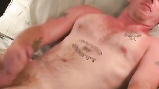 Tattooed guy shows off his buff body before tugging his meat