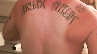 Tattooed guy shows off his buff body before tugging his meat