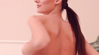 To tease you a woman with a ponytail moves around naked