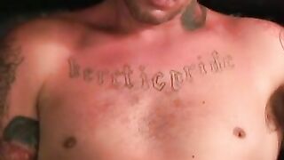 Tattooed dude tugging on his cock until he cums on his belly