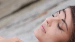 The gorgeous brunette who has a slim body gently strokes it