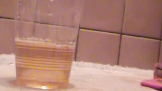 Delightful Japanese chick sits on the latrine and pees in a cup