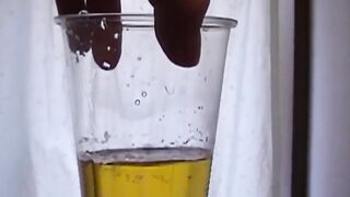 Delightful Japanese chick sits on the latrine and pees in a cup