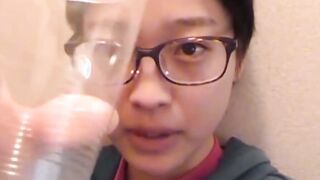 Delightful Japanese chick sits on the latrine and pees in a cup