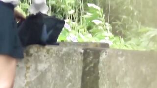 Adorable Japanse student with braids pees in the breeze