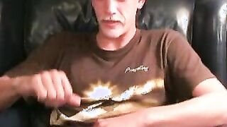 Charming inked lad lays back and pulls on his massive dong