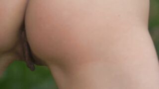 Beautiful girl moves her body passionately in a field