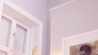 A flirtatious woman removes her underwear for solitary arousal