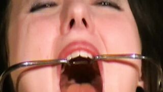 Brunette in a dental gag trained to obey without question