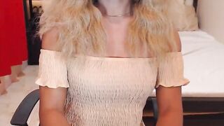 Asain blonde TS wanks cock in chair in front of webcam