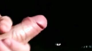 Good looking young man strokes his dick on the balcony solo
