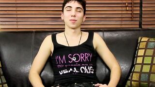 Young tattooed cutie moans while massaging his cock and balls