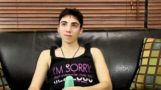 Young tattooed cutie moans while massaging his cock and balls
