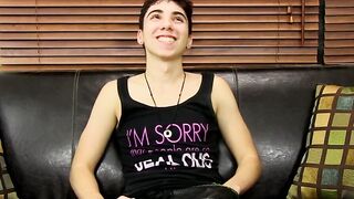 Young tattooed cutie moans while massaging his cock and balls