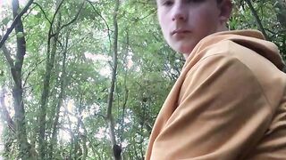 Perverted young gay dude tugs his big dick in the forest