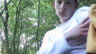Perverted young gay dude tugs his big dick in the forest