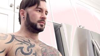 Muscular tattooed gay hunk strokes his huge cock solo