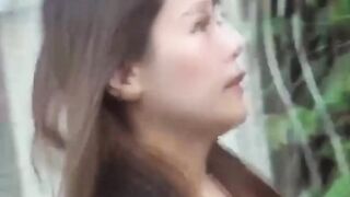 Japanese brunette squats while pissing outside