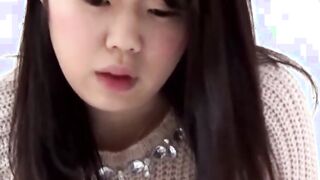 Asian dollface lifts her skirt up to show how she pees