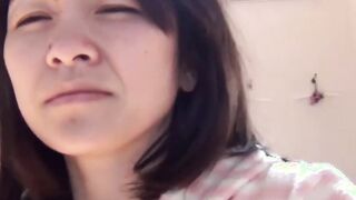 Japanese chick awakens and pees in a container while on the floor
