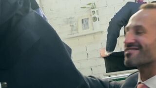 Hunk rimms in a suit and tie comfortingly pounding an irate boss