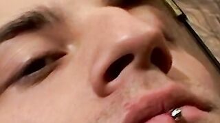 Smoking twink plays with his cock and enjoys it so much
