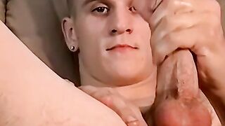 Tattooed hunk grabs his giant long sword and masturbates