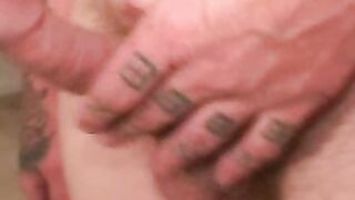Rough mature thug wanks cock with inked hand and cums