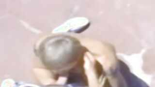 A traditional blowjob competition is taking place outside between young men