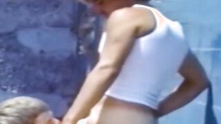 A traditional blowjob competition is taking place outside between young men