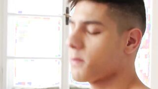 Tattooed twink strokes his enormous dick and spits out hot cum