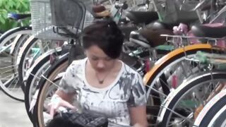 Tantalizing Japanese girl peeing in front of someone bicycle